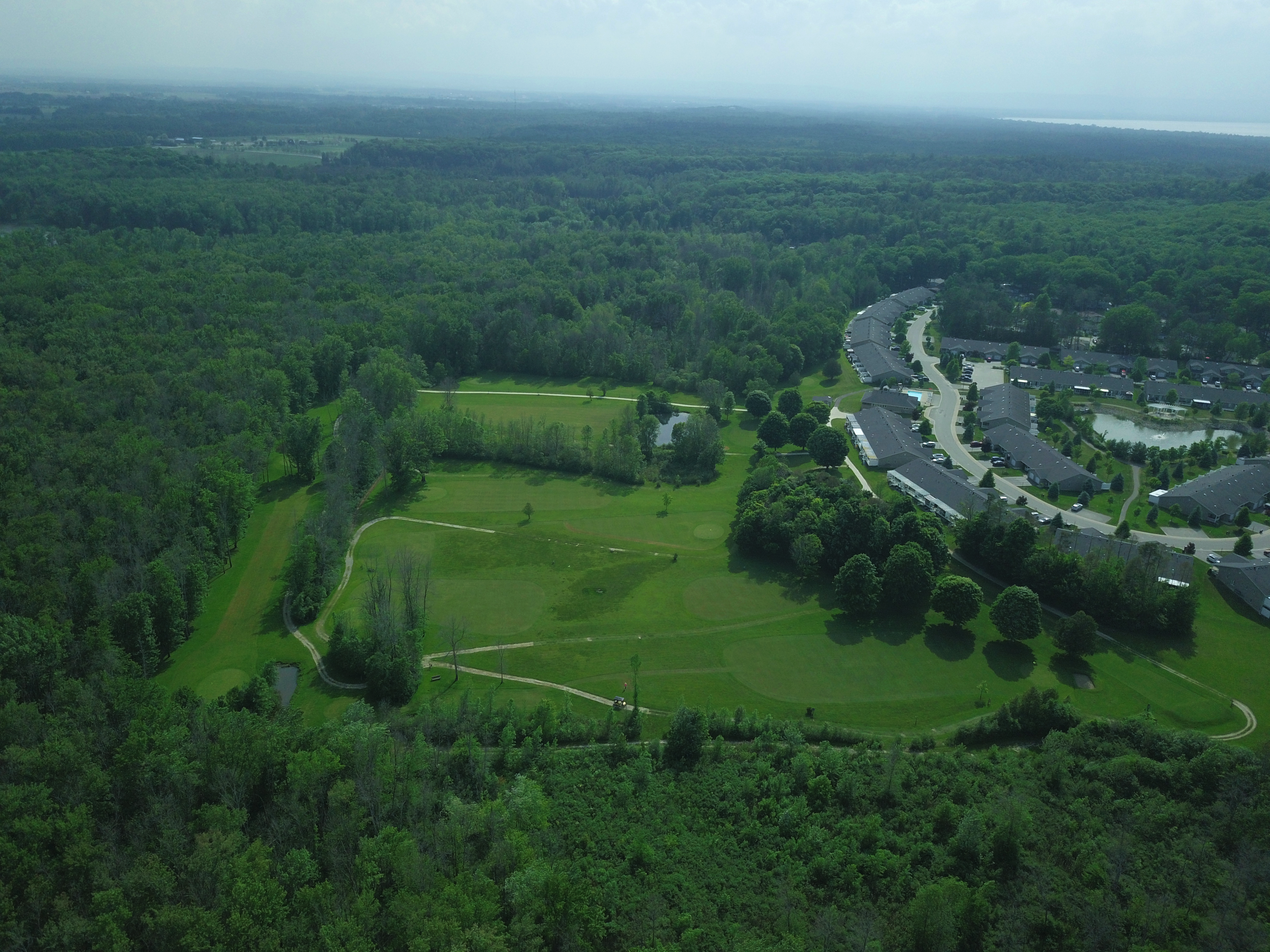 Aerial view of a golf course and residential area