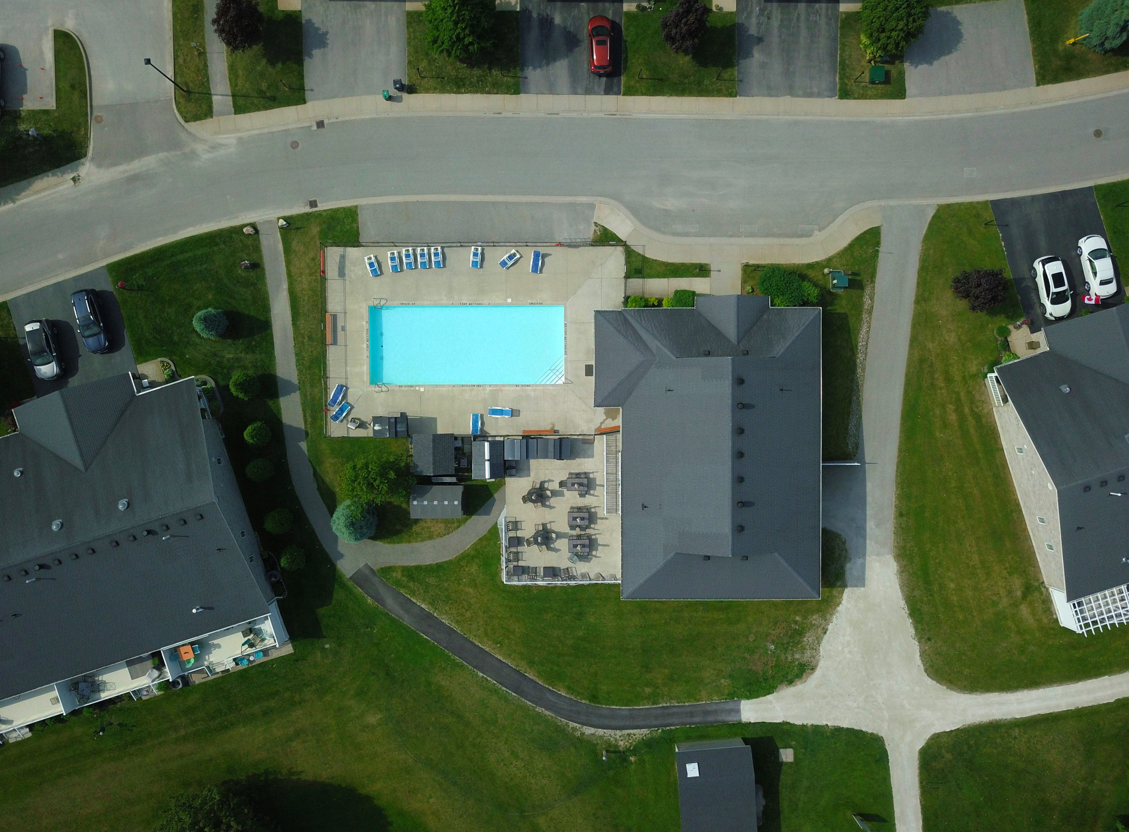 Top-down view of a community pool and clubhouse