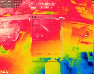 A thermal image of a commercial roof showing a hot spot that indicates a water leak